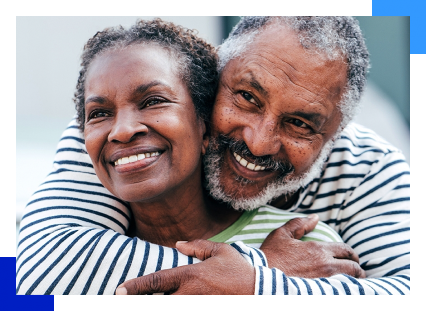 Man and woman hugging facing camera